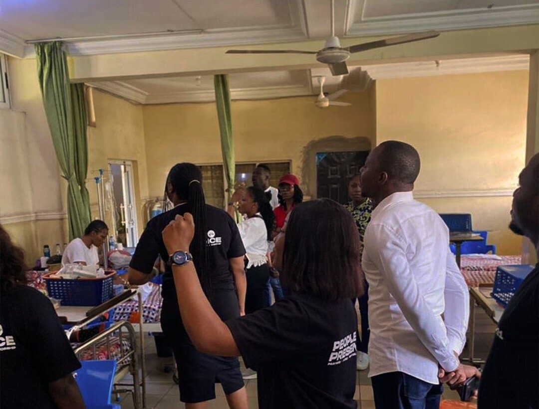 Members praying together during a hospital outreach visit